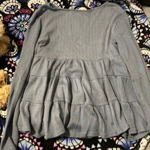 A blue long sleeve ruffle shirt from altered state.